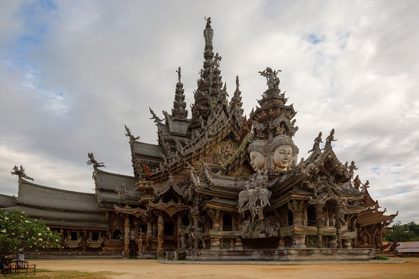 Sanctuary of Truth is a temple construction in Pattaya, Thailand. The sanctuary is an all-wood building filled with sculptures based on traditional Buddhist and Hindu motifs. It features contemporary Visionary art based on traditional religious themes. The style of the sanctuary evokes Khmer architecture, displaying hand-carved wooden sculptures indicative of the imperial setting at Angkor. It has four gopura, respectively representing images from the Buddhist and Hindu religions and mythologies of Cambodia, China, India and Thailand. Within this complex, visitors will understand Ancient Life, Human Responsibility, Basic Thought, Cycle of living, Life Relationship with Universe and Common Goal of Life toward Utopia.